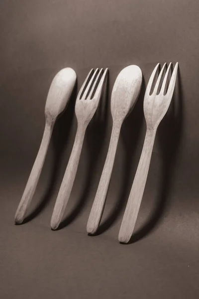 stock image Wooden spoon and wooden fork standing on the wall in black and white photography.