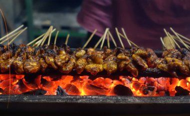 Tipik Endonezya sokak yemekleri tavuk satay, tavuk eti bambu çubuğuna eğilmiş kömürle kızartılmış ve tatlı fıstık sosuyla servis edilmiş..