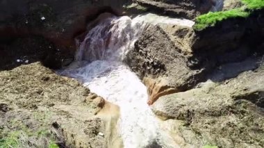 aerial view of underground sinkhole waterfall as water flows video
