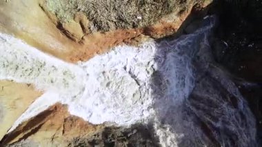 aerial view of underground sinkhole waterfall as water flows video