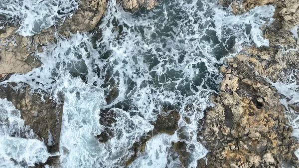 用无人驾驶飞机拍摄海浪撞击岩石的空中图像 免版税图库图片
