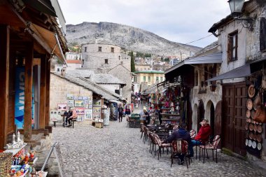 Mostar, Bosnia and Herzegovina. March 2020. Colourful buildings, street scene, shops and restaurants. On the River Neretva. 