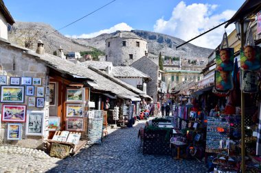 Mostar, Bosnia and Herzegovina. March 2020. Colourful buildings, street scene, shops and restaurants. On the River Neretva. 