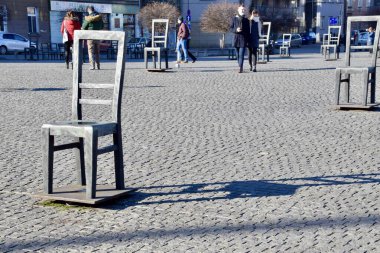  The Empty Chairs of Krakow. Ghetto Heroes Square. 70 Empty Chairs,Holocaust Memorial.  Krakow,Poland,11 February 2022.