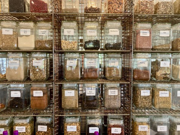 Nuts and Spices in Jars on shelving. Shop scene. Food for sale. 