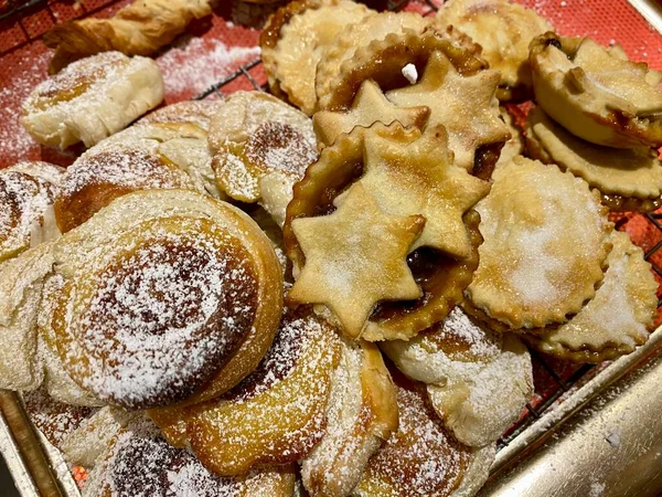 Mince Pies, British Christmas traditional sweet pastry containing chopped dried fruit. Sprinked with icing sugar.
