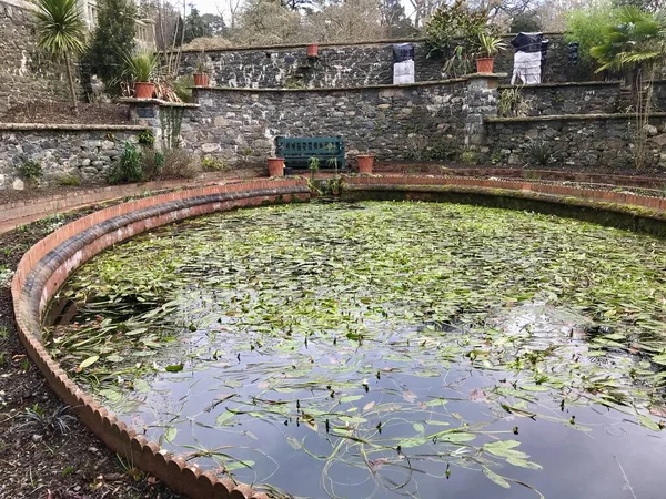 stock image Round Pond with brick surround in walled garden. Colwyn Bay, Wales. Colwyn Bay, UK, February 17, 2019. 