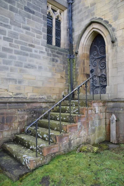 Stone Steps up the side of a stone church building. Derbyshire, UK.