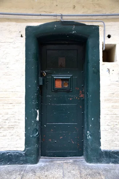 stock image Rustic Green Prison Cell Door in 17th Century Gaol. Dublin, Ireland. 