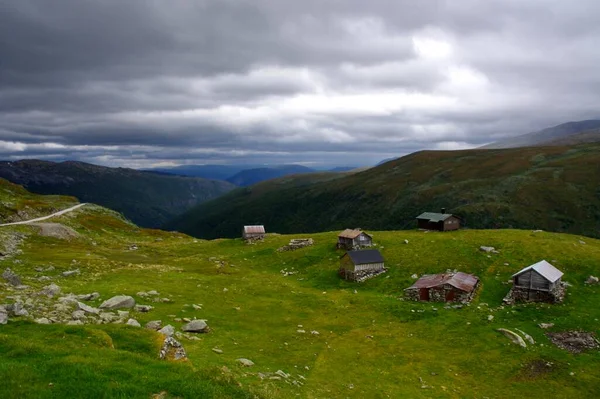 stock image A group of Traditional Nordic wooden buildings under a stormy sky on Aurlandsfjellet (The Snow Road) Norway. 