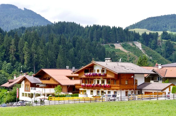 Stock image Hopfgarten im Brixental, Austria, July 29, 2013. Traditional Tyrolean buildings with mountains behind