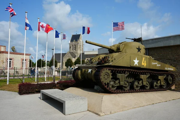 stock image US Sherman Tank outside The Airborne Museum with The Church Behind. Sainte Mere Eglise, France, July 3, 2023. 