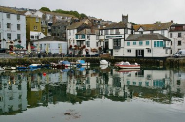 Suya ve The Chain Locker Pub 'a yansıyan tekneli gümrük binası rıhtımı. Falmouth, Cornwall, İngiltere. 6 Ağustos 2011. 