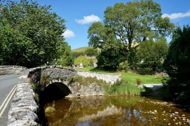 Historic stone bridge over Malham Beck on The Pennine Way. Malham, Yorkshire Dales, England, UK. August 14, 2024.  clipart