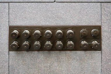 Metal standpipe and sprinkler on a granite building wall. San Francisco, California, USA. September 2024.  clipart