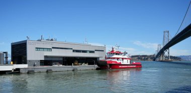 San Francisco Fire Department Fireboat 3 moored at The Fire Station with Oakland Bay Bridge behind. San Francisco, California, USA. September 2024.  clipart