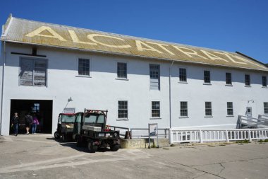 The Quartermaster Building with Alcatraz written on the roof under a blue sky. Alcatraz Island, San Francisco, CA, USA. September 2024.  clipart