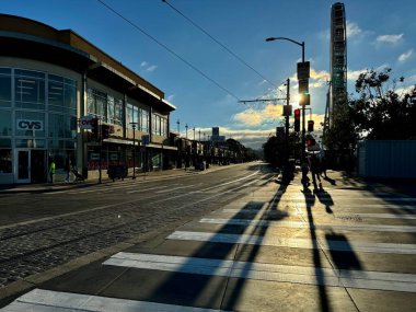 Atmospheric sunset view of the pedestrian crossing at Embarcadero and Jefferson with the Sky Star ferris wheel. San Francisco, CA, USA. September 2024.  clipart