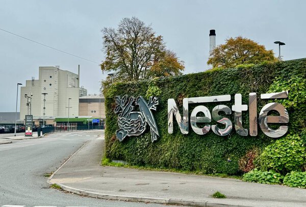 The Nestle sign and logo outside the Nestle Factory, Hatton, Derbyshire, UK. October 2024. 