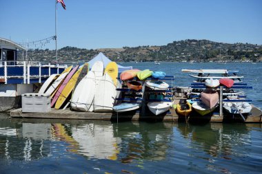 Rowing Boats and Canoes stacked up close to Sausalito Cruising Club, Sausalito, California, USA. September 2024.  clipart