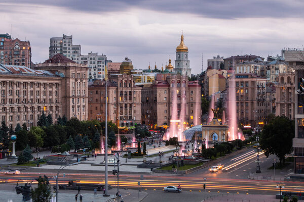 The European square in Kiev, Ukraine before the War, Majdan Nezalezjnosti. High quality photo with fading light in blue hour evening. Street lights and cars are visible, light illuminate the statues