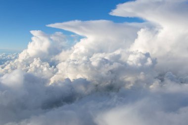 A line of thunderstorms as seen from the air. Cumulus nimbus clouds and a deep blue sky. High quality photo