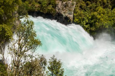 Huka Falls in New Zealand. Fast surging water through green foliage. High quality photo