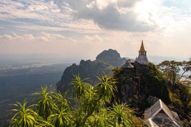 Wat Phutthabat Sutthawat, tepedeki tapınak ve yeşil tepe ve kayadaki stupa. Yüksek uçurumlar ve renkli tapınaklar. Yüksek kalite fotoğraf