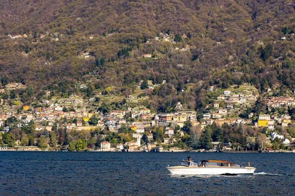 stock image Lago di Como, Lake Como, Italy, with Palacios, grand houses in spring. Watertaxi, Riva, typical Italian boat. Blue skies and vibrant colours. High quality photo