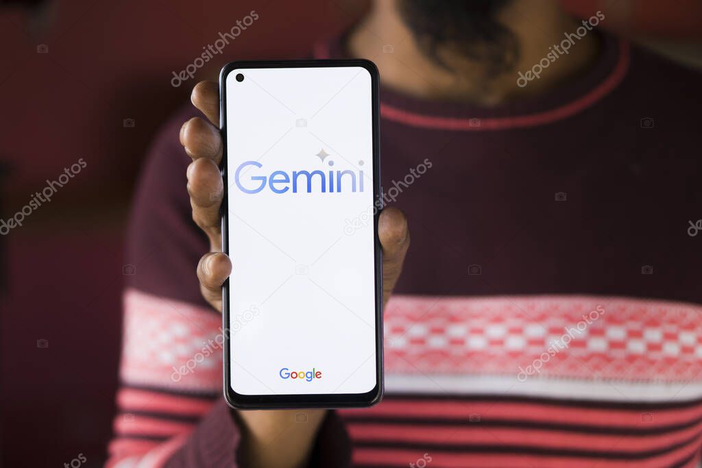 Dhaka, Bangladesh - 27 December 2023: Hand holding a phone with Google Gemini AI chatbot Gemini is a family of multimodal large language models developed by Google.