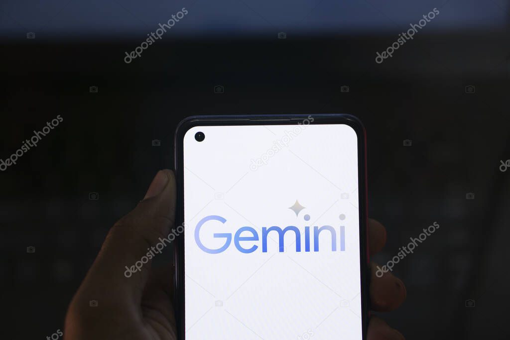 Dhaka, Bangladesh - 27 December 2023: Hand holding a phone with Google Gemini AI chatbot Gemini is a family of multimodal large language models developed by Google.