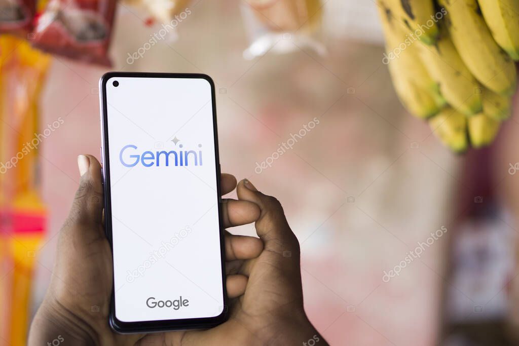 Dhaka, Bangladesh - 27 December 2023: Hand holding a phone with Google Gemini AI chatbot Gemini is a family of multimodal large language models developed by Google.