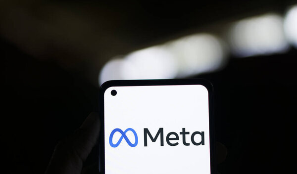 Dhaka, Bangladesh - 01 January 2024: Hand holding a phone with Meta. Meta is an American multinational technology company.