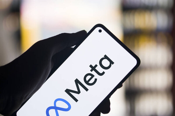 Dhaka, Bangladesh - 01 January 2024: Hand holding a phone with Meta. Meta is an American multinational technology company.