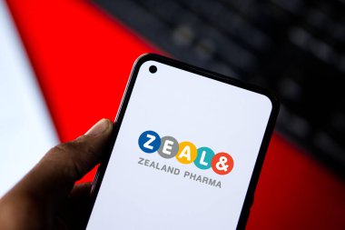 Dhaka, Bangladesh - 10 Aug 2024: Zealand Pharma logo is displayed on smartphone. clipart