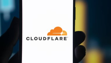 Dhaka, Bangladesh- 05 Aug 2024: CloudFlare logo is displayed on smartphone. Cloudflare is a US-based tech firm offering website security, performance, and reliability services. clipart