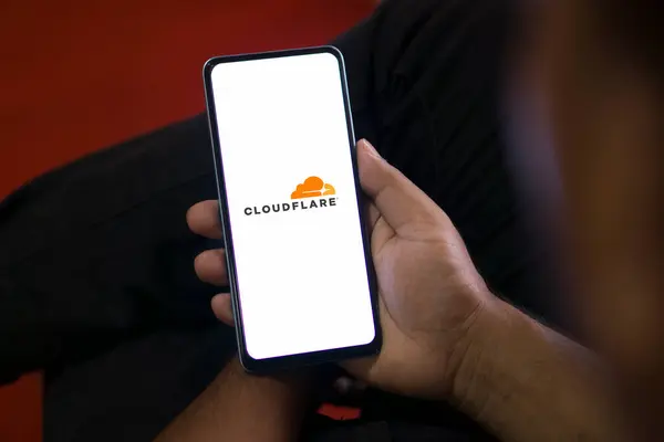 stock image Dhaka, Bangladesh- 05 Aug 2024: CloudFlare logo is displayed on smartphone. Cloudflare is a US-based tech firm offering website security, performance, and reliability services.