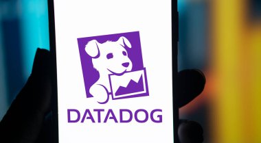 Dhaka, Bangladesh- 11 Aug 2024: DataDog logo is displayed on smartphone. Datadog is a SaaS platform that monitors cloud applications. clipart