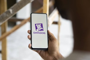 Dhaka, Bangladesh- 11 Aug 2024: DataDog logo is displayed on smartphone. Datadog is a SaaS platform that monitors cloud applications. clipart