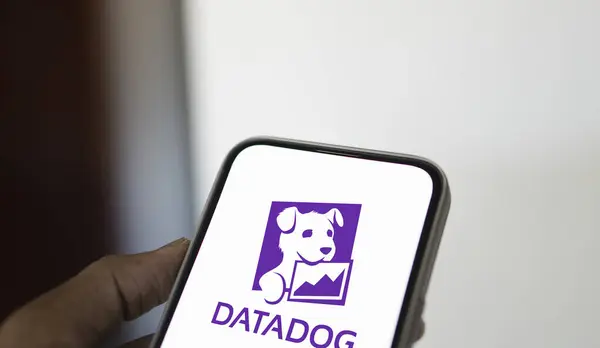 stock image Dhaka, Bangladesh- 11 Aug 2024: DataDog logo is displayed on smartphone. Datadog is a SaaS platform that monitors cloud applications.