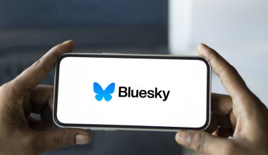 Dhaka, Bangladesh- 05 Aug 2024: Bluesky logo is displayed on smartphone. Bluesky is a  microblogging social platform. clipart