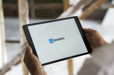 Dhaka, Bangladesh- 07 Sep 2024: Shareit logo is displayed on  iPad. SHAREit sends files without internet or Bluetooth. clipart