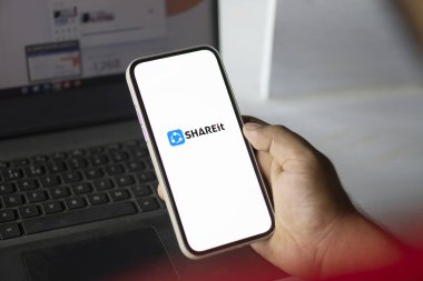 Dhaka, Bangladesh- 07 Sep 2024: Shareit logo is displayed on  smartphone. SHAREit sends files without internet or Bluetooth. clipart