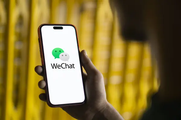 stock image Dhaka,  bangladesh- 18 Sep 2024: WeChat  logo is displayed on smartphone.