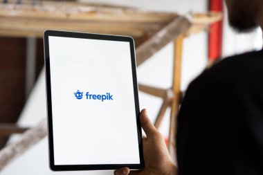 Dhaka, Bangladesh- 19 Sep 2024: Freepik logo is displayed on iPad. clipart