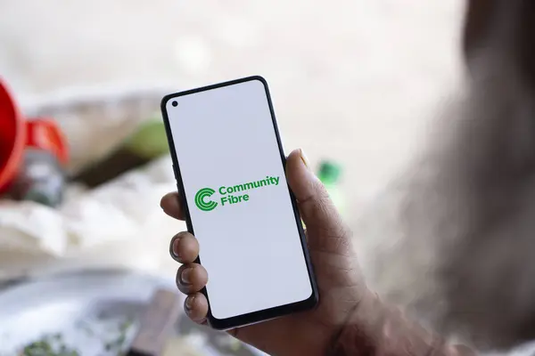 stock image Dhaka, Bangladesh- Community Fiber logo is displayed on smartphone.