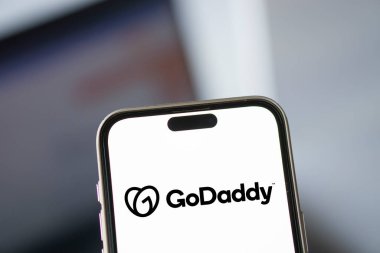 Dhaka, Bangladesh- 13 Oct 2024: GoDaddy logo is displayed on smartphone. clipart