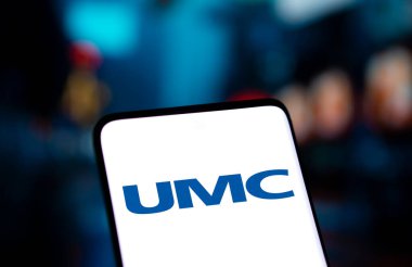 Dhaka, Bangladesh- 05 Nov 2024: United Microelectronics Corporation (UMC) logo is displayed on smartphone. clipart