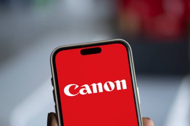 Dhaka, Bangladesh- 09 Nov 2024: Canon logo is displayed on smartphone.Canon Inc is a Japanese multinational corporation. clipart