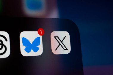 Dhaka, Bangladesh- 26 Nov 2024: A close up of an iPhone screen displaying the X (twitter) app icon and the Bluesky app icon. clipart